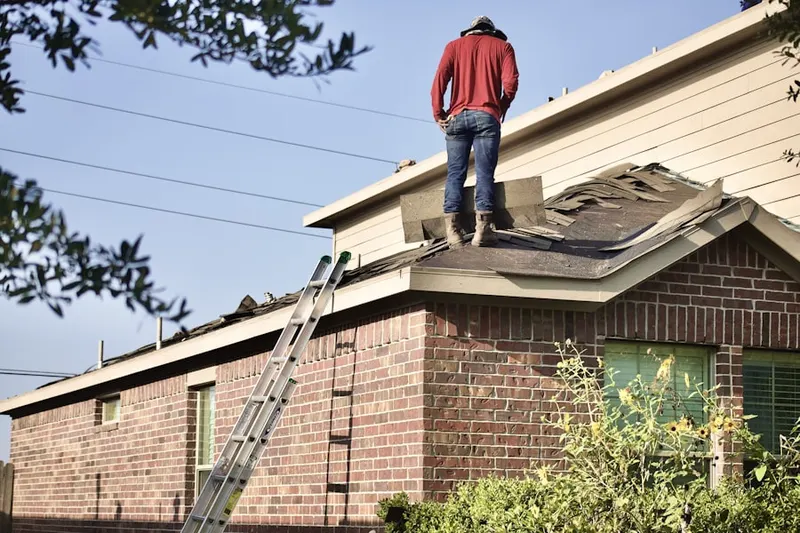 Professional roofer working on a residential roof in Redhawk